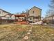 Expansive backyard with a deck, patio, hot tub, pergola, lush lawn, and mature trees at 11395 E 116Th Dr, Commerce City, CO 80640