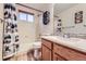 Bright bathroom featuring a shower-tub combination and decorative woodland themed art at 11395 E 116Th Dr, Commerce City, CO 80640