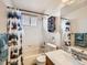 Well-lit bathroom with shower-tub combo, and single sink vanity with quartz countertops at 11395 E 116Th Dr, Commerce City, CO 80640