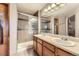 Bathroom showcasing a walk-in shower with glass doors and a double sink vanity at 11395 E 116Th Dr, Commerce City, CO 80640