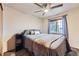 Comfortable bedroom with a large window and stylish decor and ceiling fan at 11395 E 116Th Dr, Commerce City, CO 80640