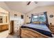 Well-lit bedroom with natural wood furniture, a vaulted ceiling, and easy bathroom access at 11395 E 116Th Dr, Commerce City, CO 80640