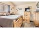 Bedroom with a bed, window with blinds, and a dresser with a TV on top at 11395 E 116Th Dr, Commerce City, CO 80640
