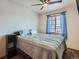 Bedroom featuring a bed, window with blinds, and a dark bedside table at 11395 E 116Th Dr, Commerce City, CO 80640