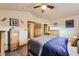 Comfortable bedroom features natural wood furniture and easy access to an adjacent bathroom at 11395 E 116Th Dr, Commerce City, CO 80640