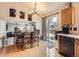 Dining area with wood floors and chandelier has sliding glass door to the outside at 11395 E 116Th Dr, Commerce City, CO 80640