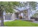 Charming two-story home with a well-maintained lawn, a two car garage, and stone accents at 11395 E 116Th Dr, Commerce City, CO 80640