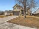 A two-story home with neutral siding, a two-car garage, and well-maintained landscaping at 11395 E 116Th Dr, Commerce City, CO 80640