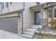 Charming home entrance with a gray front door, stone accents, and a well-maintained front yard at 11395 E 116Th Dr, Commerce City, CO 80640