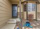 Inviting front entrance with stone accents, covered porch, and decorative landscaping at 11395 E 116Th Dr, Commerce City, CO 80640