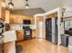 Well-equipped kitchen with stainless steel appliances, light wood cabinets and hardwood floors at 11395 E 116Th Dr, Commerce City, CO 80640