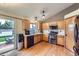 Bright kitchen with wooden cabinets, stainless steel oven, and sliding doors leading to backyard at 11395 E 116Th Dr, Commerce City, CO 80640