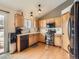 Modern kitchen featuring stainless steel appliances, wood cabinets, and hardwood floors at 11395 E 116Th Dr, Commerce City, CO 80640