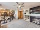 Cozy living area features a fireplace, built-in shelving, and easy access to the kitchen and stairs at 11395 E 116Th Dr, Commerce City, CO 80640