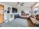 Living room features a fireplace, neutral carpet, ceiling fan, and comfortable couches at 11395 E 116Th Dr, Commerce City, CO 80640