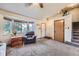 Inviting living area featuring comfortable seating, a large bay window, and easy access to the home's entryway at 11395 E 116Th Dr, Commerce City, CO 80640