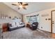 Bright living room featuring neutral colors, vaulted ceiling, a cozy sofa, armchair, and a bay window at 11395 E 116Th Dr, Commerce City, CO 80640