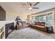 Spacious living room with a fireplace and a large bay window for ample natural light at 11395 E 116Th Dr, Commerce City, CO 80640