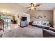 Open-concept living room with modern decor, featuring plush seating and seamless flow to the adjacent kitchen at 11395 E 116Th Dr, Commerce City, CO 80640