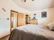 Cozy main bedroom features wood accents, ensuite bathroom, and a comfortable queen sized bed at 11395 E 116Th Dr, Commerce City, CO 80640