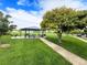 Community park featuring a covered picnic area with tables and a grill on a sunny day at 11395 E 116Th Dr, Commerce City, CO 80640