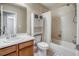 Bathroom featuring a shower, toilet, and sink with a wooden cabinet base at 3810 Cadence Dr, Castle Rock, CO 80109