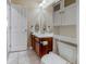 Bathroom with modern sink and toilet adjacent to a large mirror and storage cabinet at 3810 Cadence Dr, Castle Rock, CO 80109