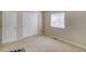 Bright bedroom with double doors and a window, providing ample storage and natural light at 3810 Cadence Dr, Castle Rock, CO 80109