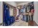 Walk-in closet featuring metal racks, carpet flooring, and clothing hung in an organized fashion at 3810 Cadence Dr, Castle Rock, CO 80109