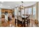 Elegant dining room with hardwood floors, stylish lighting, and a seamless connection to the modern kitchen at 3810 Cadence Dr, Castle Rock, CO 80109