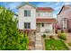 Inviting two-story home with stone accents, landscaped front yard, and charming covered porch with a red roof at 3810 Cadence Dr, Castle Rock, CO 80109