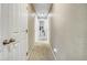 Well-lit hallway with carpet flooring leading to multiple rooms with white doors at 3810 Cadence Dr, Castle Rock, CO 80109
