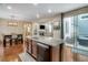 Well-designed kitchen island with granite countertop, sink, and dishwasher; open concept with dining and living areas at 3810 Cadence Dr, Castle Rock, CO 80109