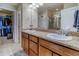 Bathroom featuring double sinks with granite countertops and a walk-in closet at 3810 Cadence Dr, Castle Rock, CO 80109