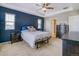 Blue accent wall in a main bedroom featuring a tray ceiling and carpeted floors at 3810 Cadence Dr, Castle Rock, CO 80109