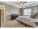 Neutral bedroom featuring a tray ceiling, a large window, and carpeted floors at 3810 Cadence Dr, Castle Rock, CO 80109