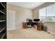 Home office with neutral carpet, a functional desk, and natural light from the window at 3810 Cadence Dr, Castle Rock, CO 80109