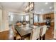 Spacious dining area with a large table, modern light fixture, and views into the open living room and kitchen at 3810 Cadence Dr, Castle Rock, CO 80109