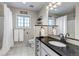 Bathroom featuring black granite countertop, vanity, framed mirror, and a shower with white shower curtain at 35427 Welch Trl, Elizabeth, CO 80107