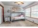Cozy bedroom featuring a bunk bed, neutral decor, and a large window at 35427 Welch Trl, Elizabeth, CO 80107