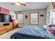 Comfortable bedroom featuring warm wood accents, American flag, and a blue quilted bedspread at 35427 Welch Trl, Elizabeth, CO 80107
