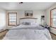 Bedroom featuring a white bed frame, wood-trimmed windows, and neutral decor at 35427 Welch Trl, Elizabeth, CO 80107