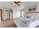 Bright bedroom featuring a white bed frame, wood-trimmed windows, and neutral decor at 35427 Welch Trl, Elizabeth, CO 80107