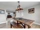 Bright dining room with a rustic table, bench seating, and decorative light fixture at 35427 Welch Trl, Elizabeth, CO 80107