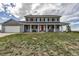 Charming two-story home with a welcoming front porch and well-manicured lawn, perfect for relaxing outdoors at 35427 Welch Trl, Elizabeth, CO 80107