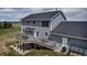 Two-story home featuring a large deck, spacious yard, and side entrance at 35427 Welch Trl, Elizabeth, CO 80107