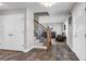 Open foyer with hardwood floors, a staircase with wrought iron details, and access to the living area at 35427 Welch Trl, Elizabeth, CO 80107