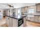 Open kitchen with island, stainless appliances, and farmhouse sink at 35427 Welch Trl, Elizabeth, CO 80107