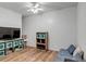 Relaxing living room with wood-look floors, blue sofa, and storage cabinets at 35427 Welch Trl, Elizabeth, CO 80107