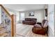 Cozy living room with comfortable seating, hardwood floors, and a view into the dining room at 35427 Welch Trl, Elizabeth, CO 80107